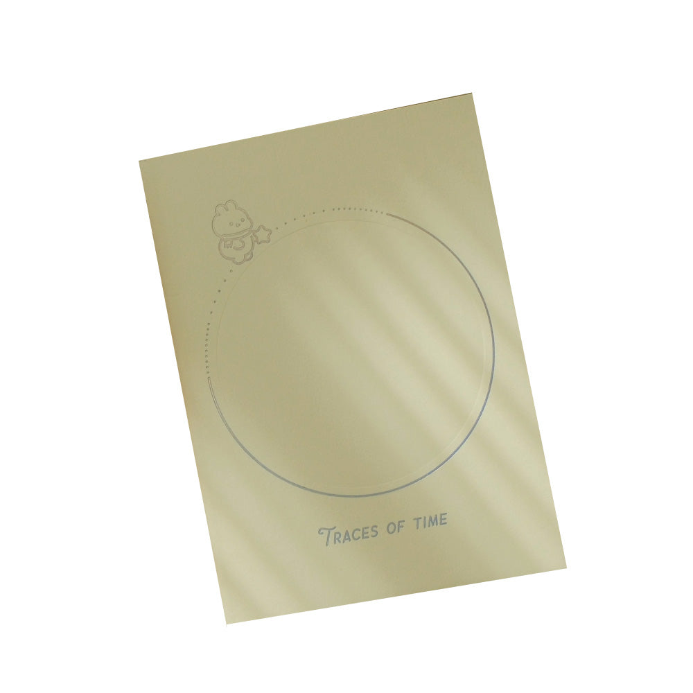 Cream color notebook with circle outline on cover.