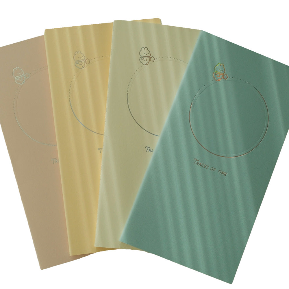 Four notebooks in different colors with a circular design and text on a white background