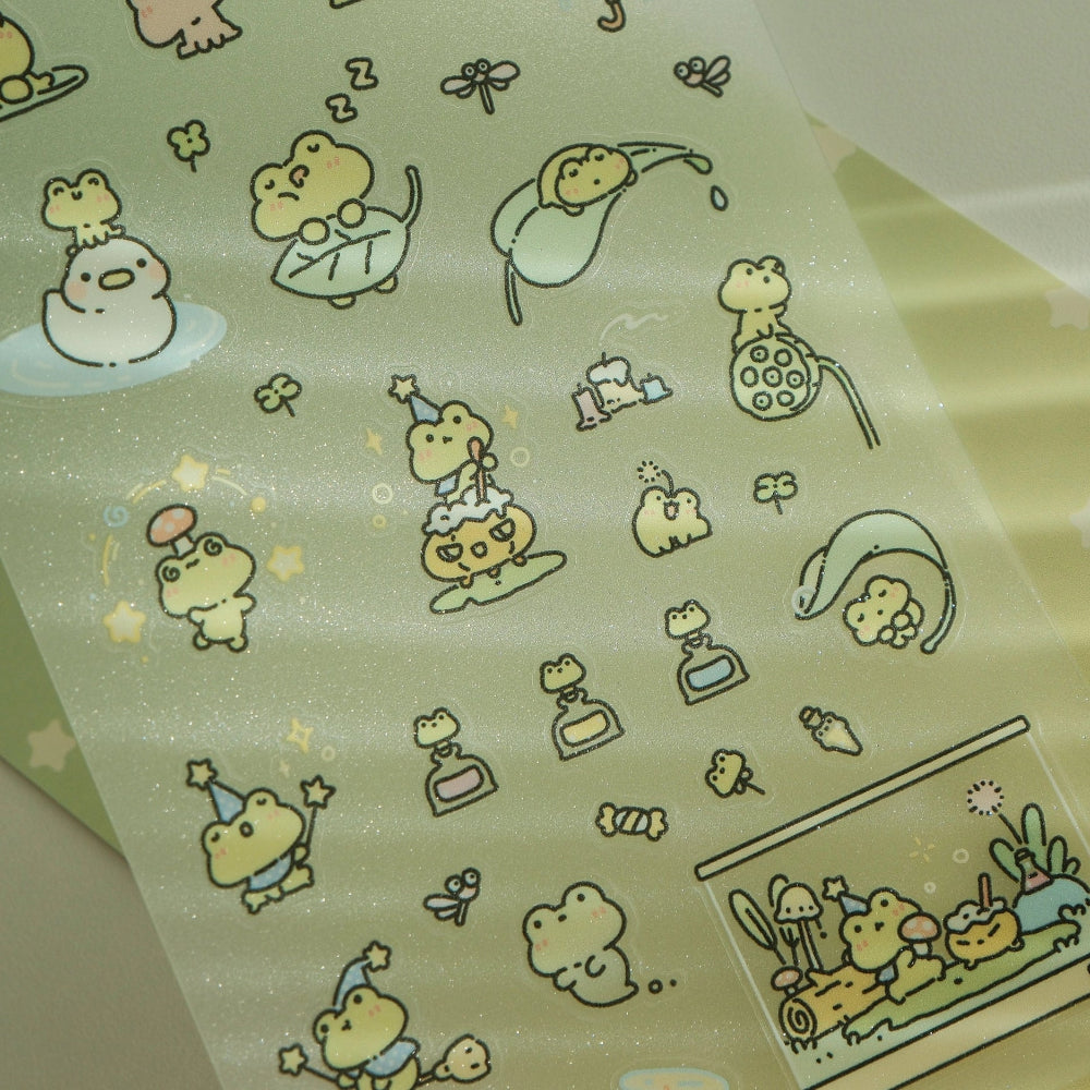 Sheet of cartoon frog stickers with various poses on a green background