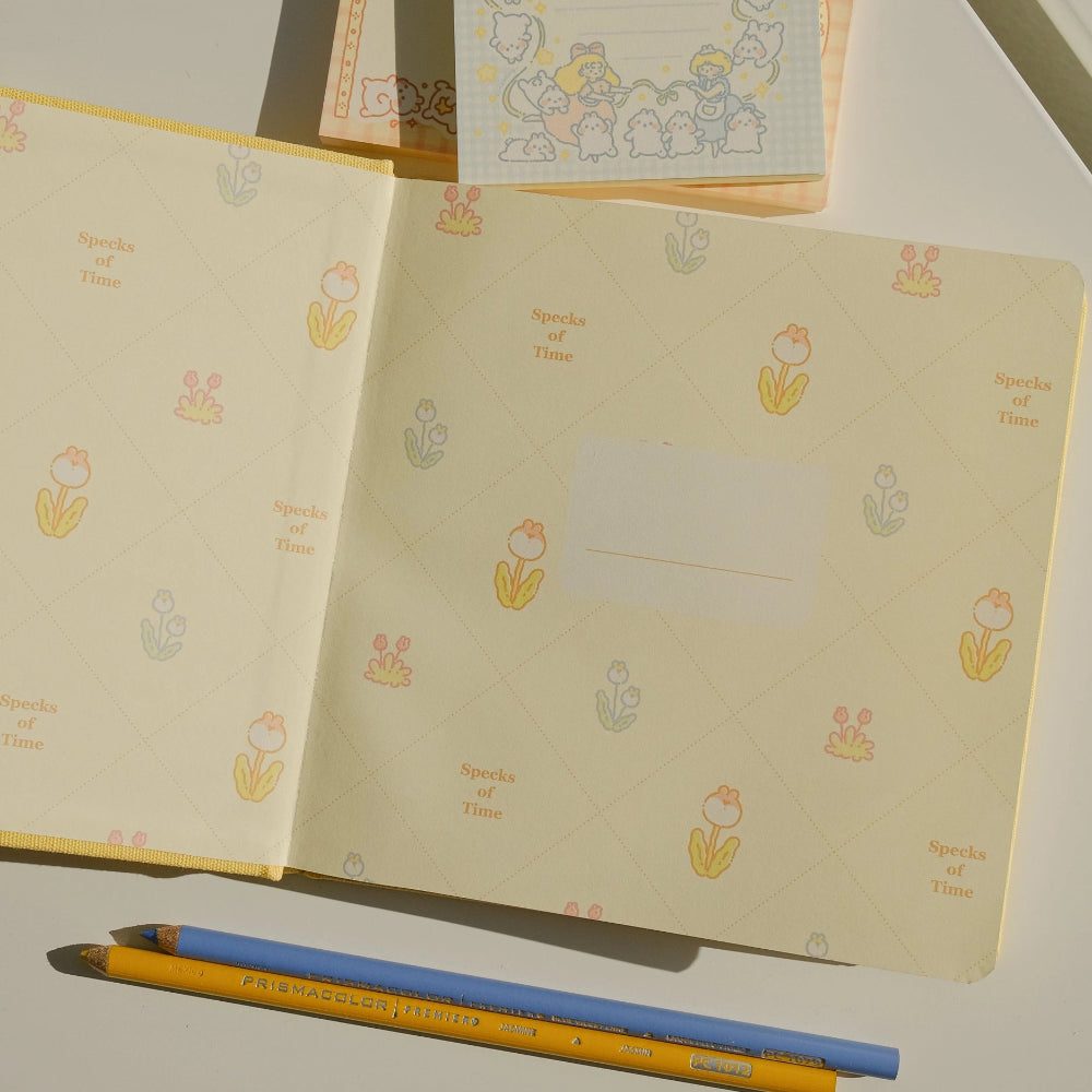 Notebooks with floral patterns and two pencils on a light surface