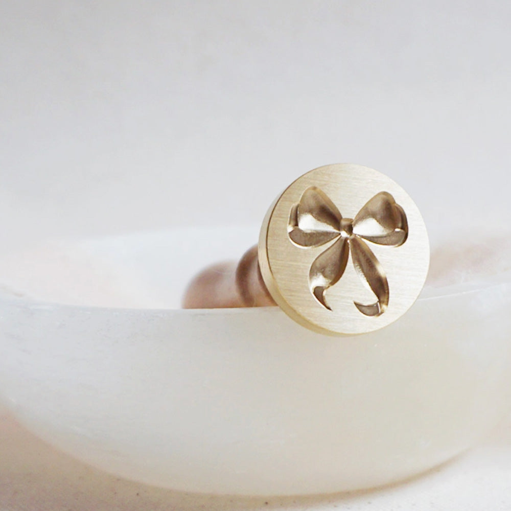 Gold wax seal head of a bow