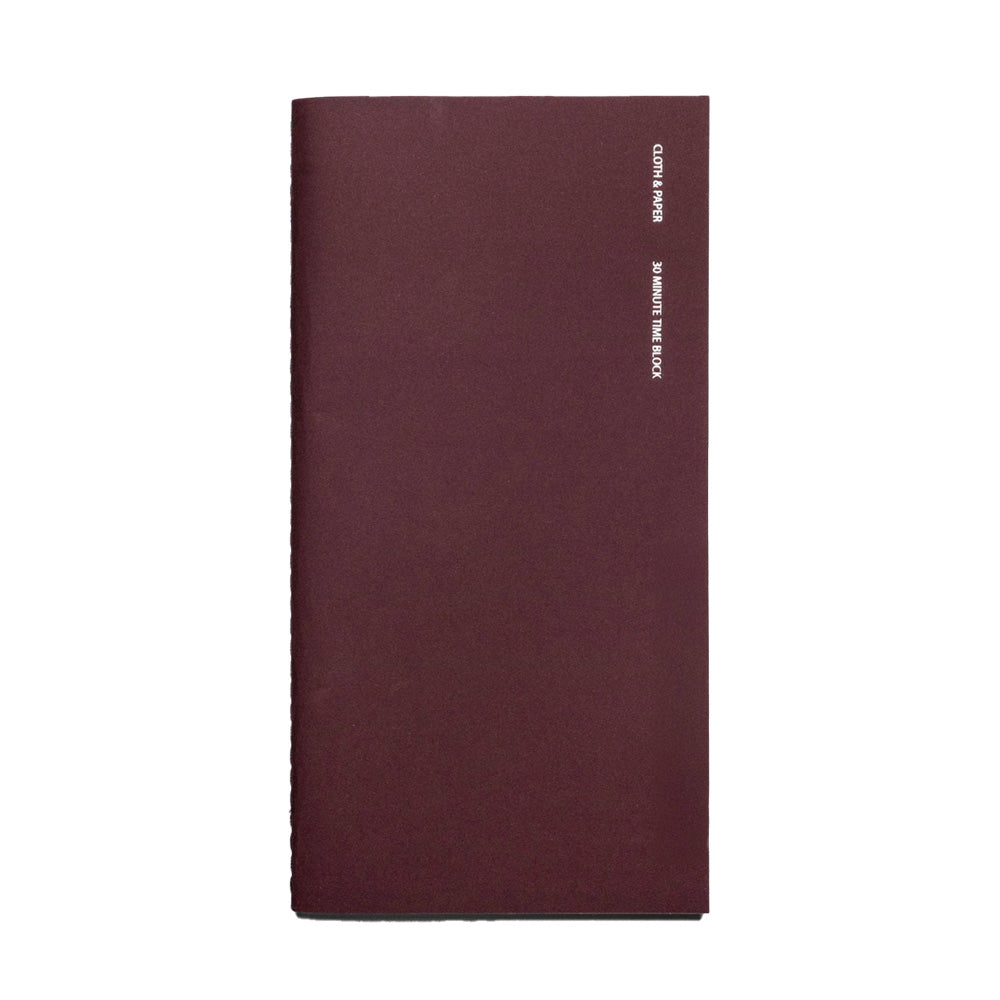 Maroon notebook with white text on a white background