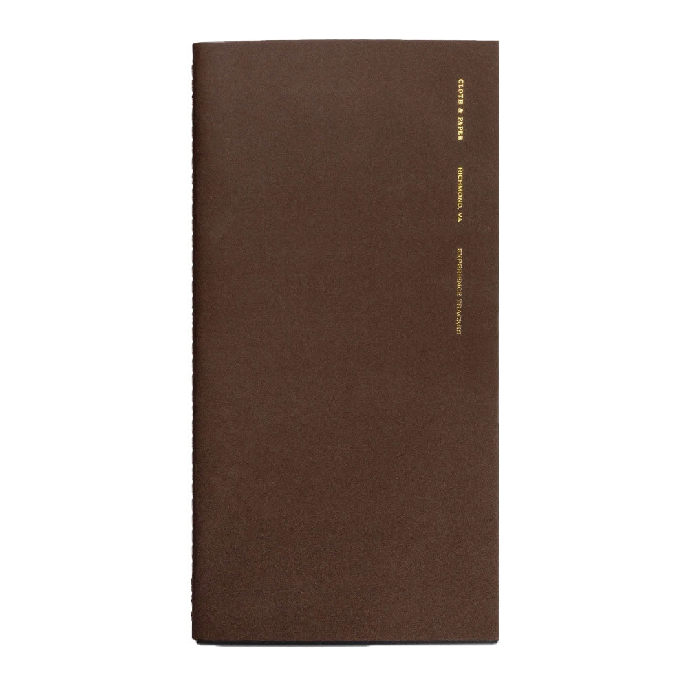 Brown notebook with gold text on a white background
