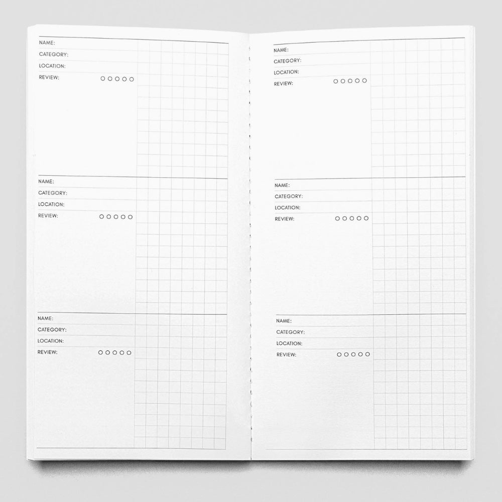 Open notebook with grid layout on a gray background