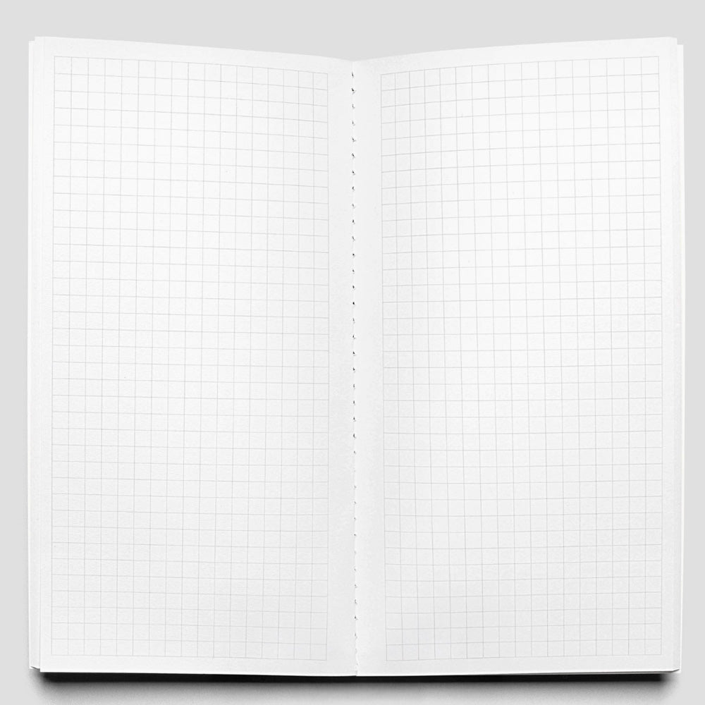 Open notebook with grid paper on a gray background