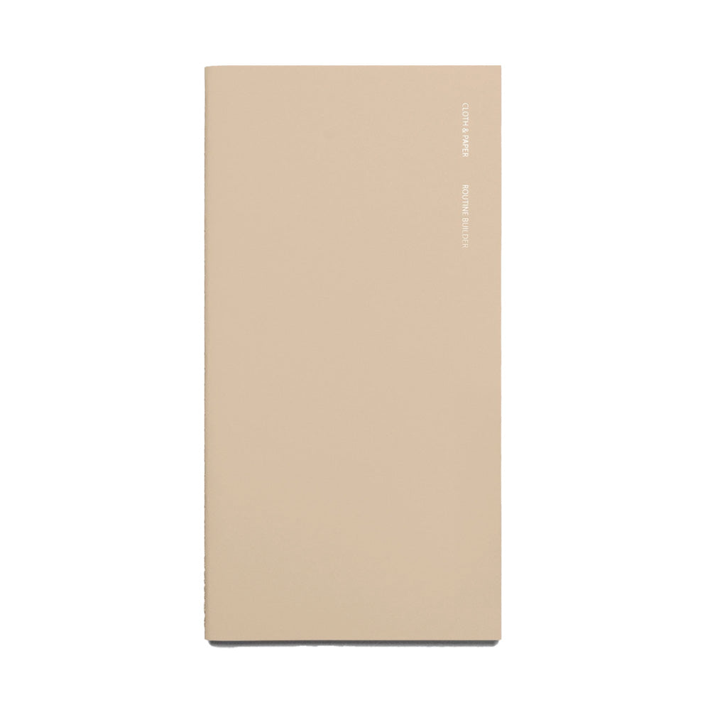 Beige notebook with foil lettering on the front