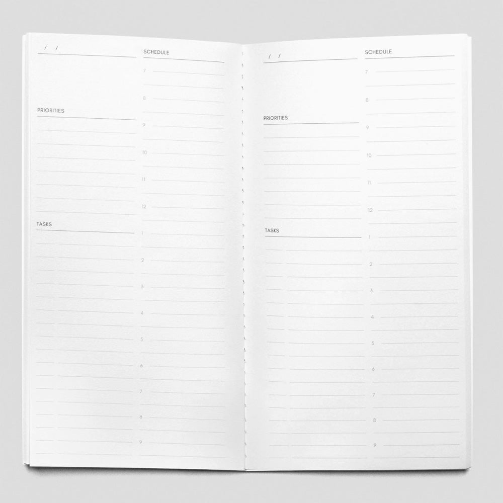 Open planner with schedule and priorities sections on a gray background