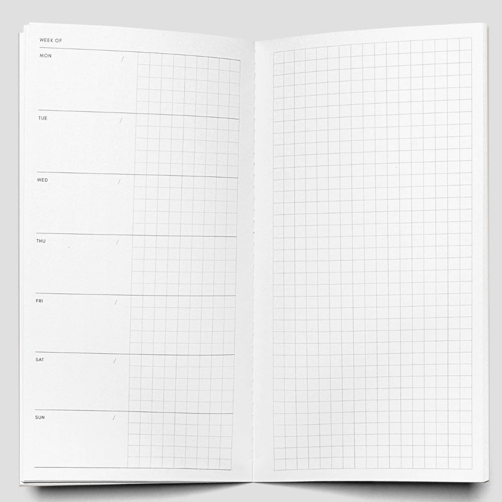 Open notebook with grid pages on a gray background
