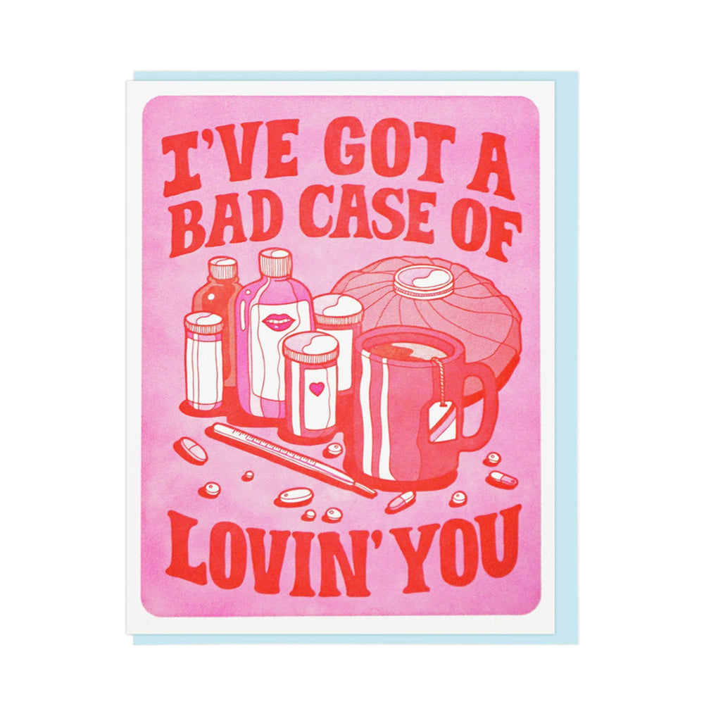 Card with pink background and red text 'I've got a bad case of lovin' you' featuring illustrations of medicine.