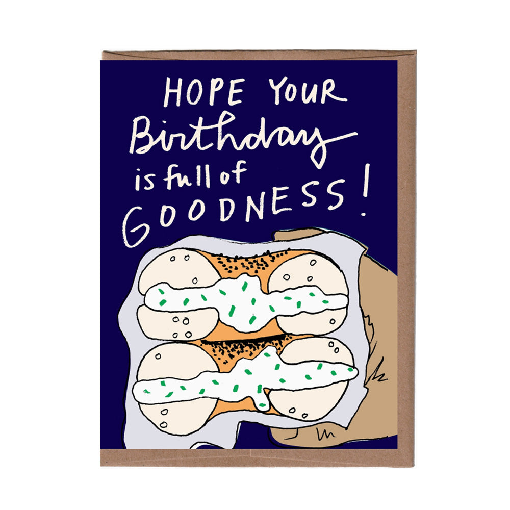 Birthday card with text 'Hope your birthday is full of goodness!' and a bagel and cream cheese illustration on a blue background.