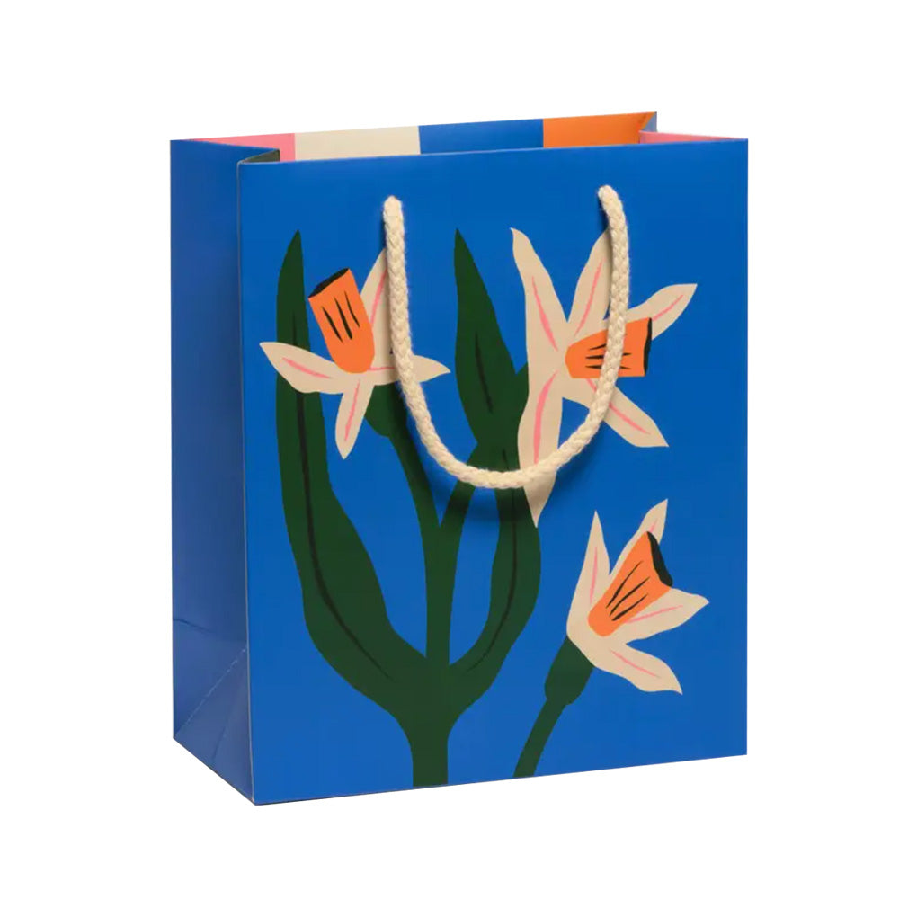 Blue gift bag with floral design and rope handles on a white background