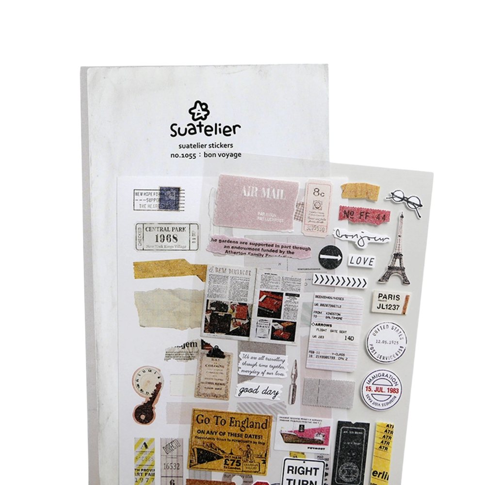 A sheet of Suatelier bon voyage stickers featuring vintage travel-themed designs, including stamps, postcards, newspaper clippings, a Eiffel Tower sticker, and travel text elements, displayed on a white background.