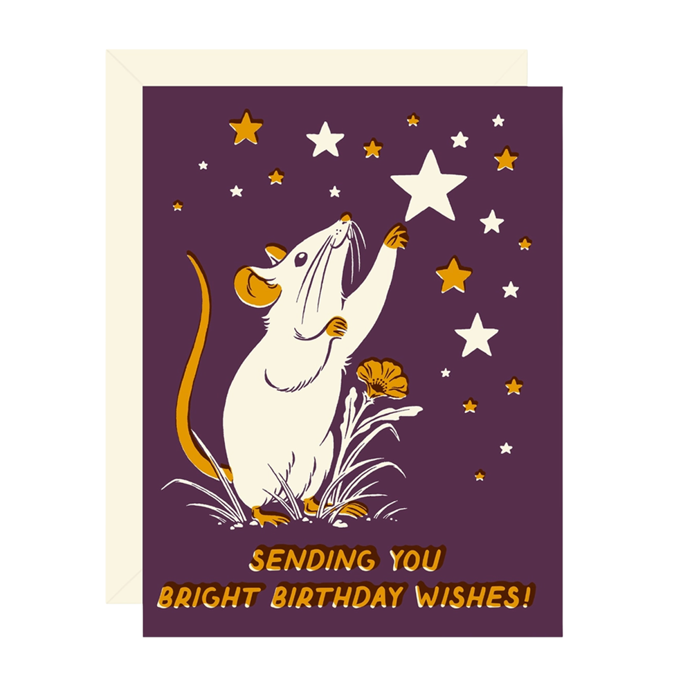 A birthday greeting card with a purple background, featuring an illustration of a white mouse reaching toward stars, with the text 'SENDING YOU BRIGHT BIRTHDAY WISHES!' at the bottom. The card is shown with a cream envelope behind it on a white background.