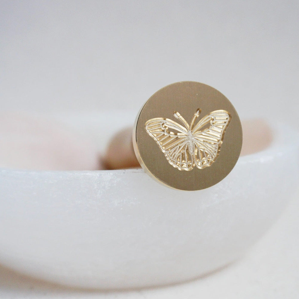 Gold wax seal head with a butterfly