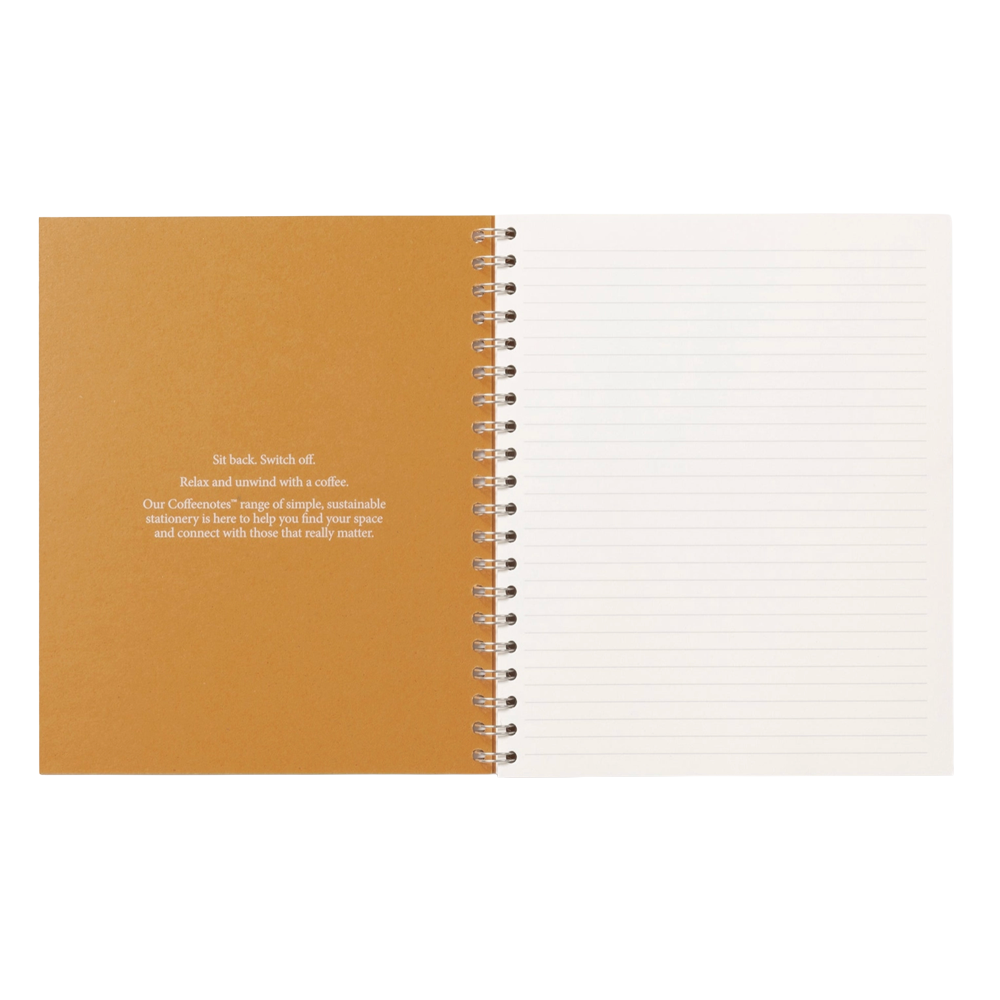 An open spiral notebook with a warm tan left page containing printed text and a white right page with horizontal lines, shown on a plain white background.