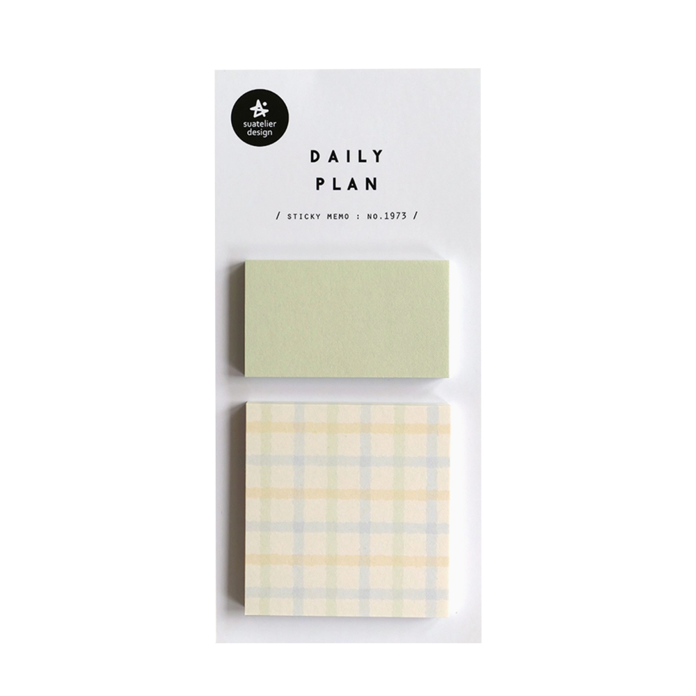 Two sticky notes with different designs, a plain green and a pastel yellow grid, on a white background