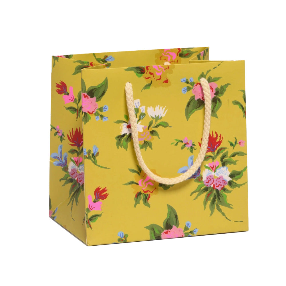 Floral-patterned paper bag with a yellow background