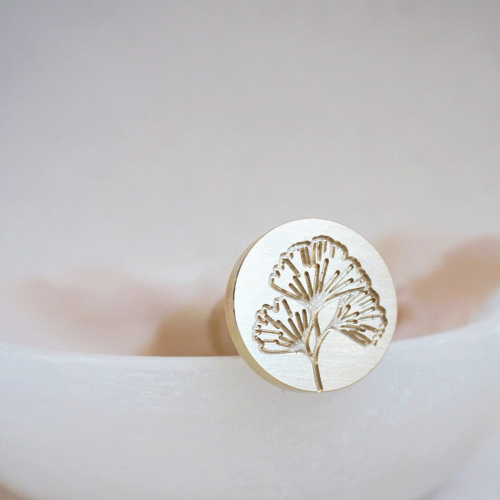 Gold wax seal with a Gingko leaf on it