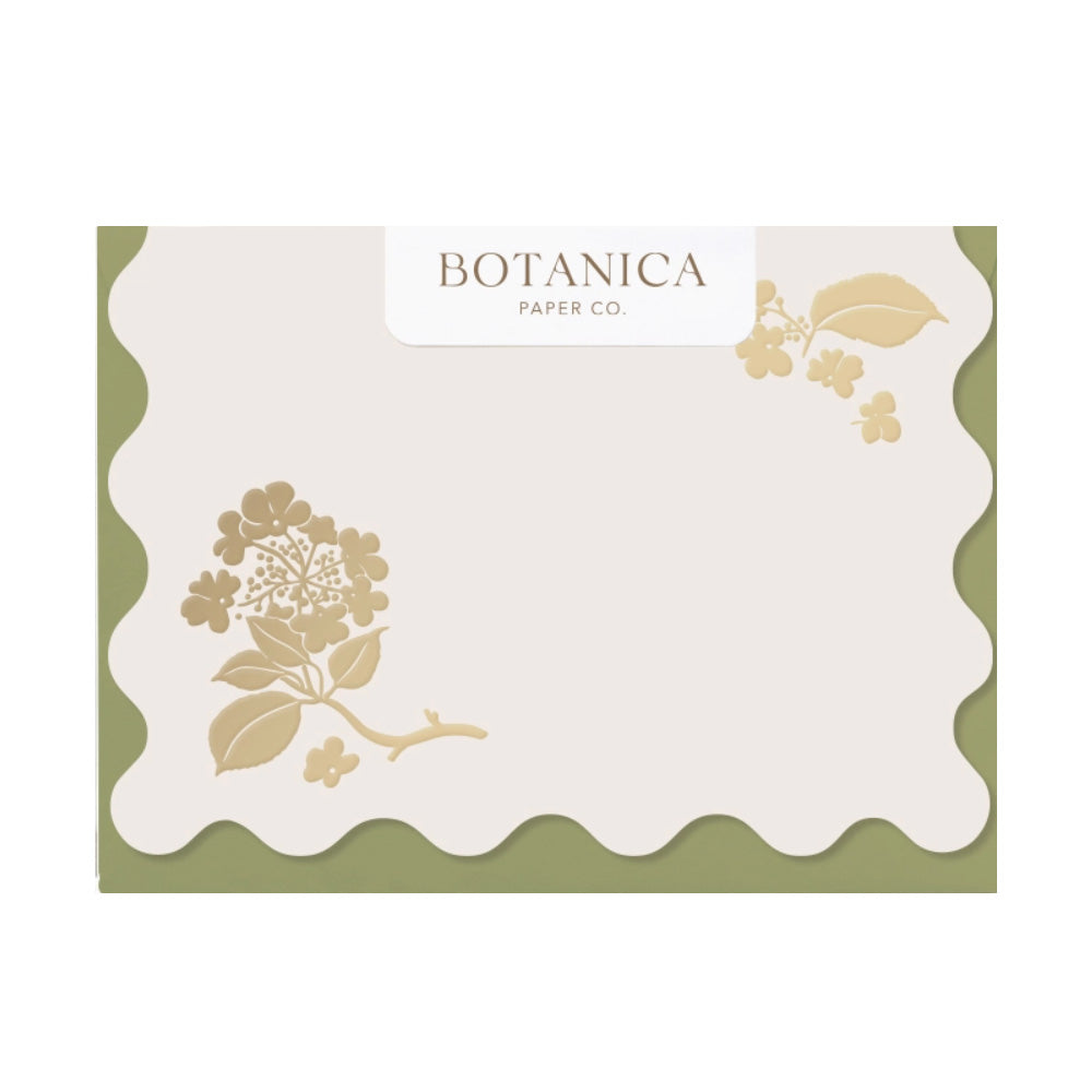 A box of scalloped edge blank cards with a gold foil flower in the top right and bottom left corner.