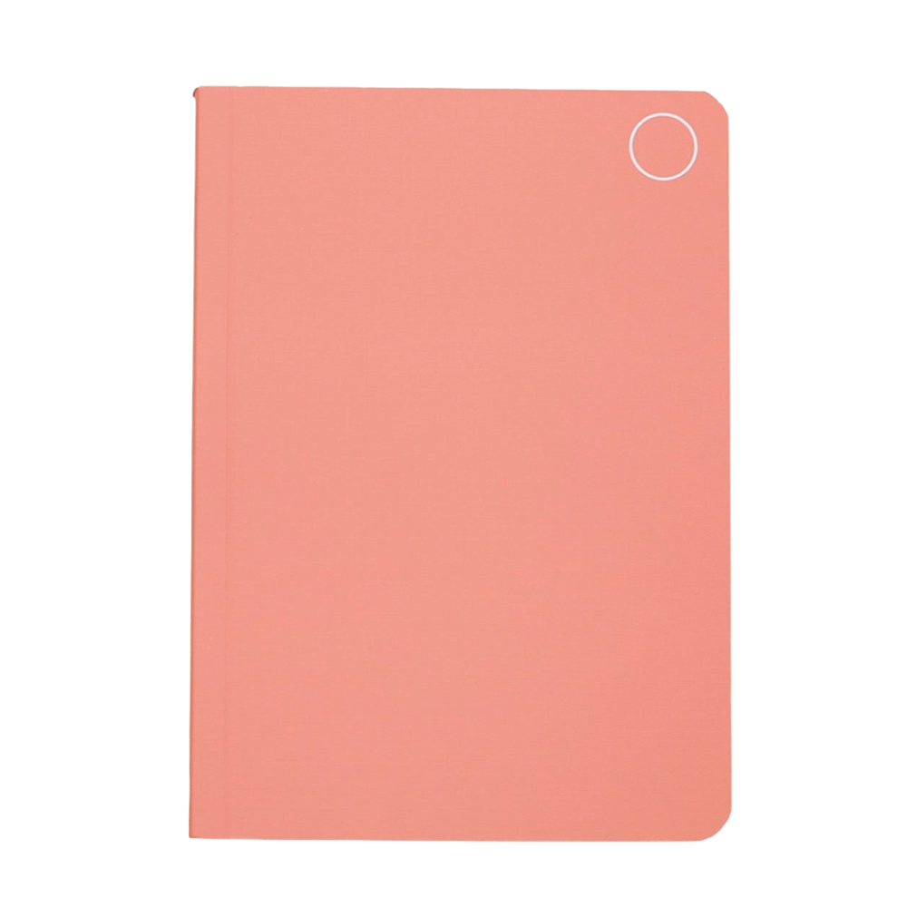 A light pink soft cover notebook with a circle logo in the top right corner.