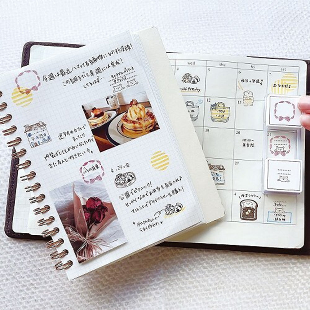 Notebook with decorative stickers and photos on a white surface