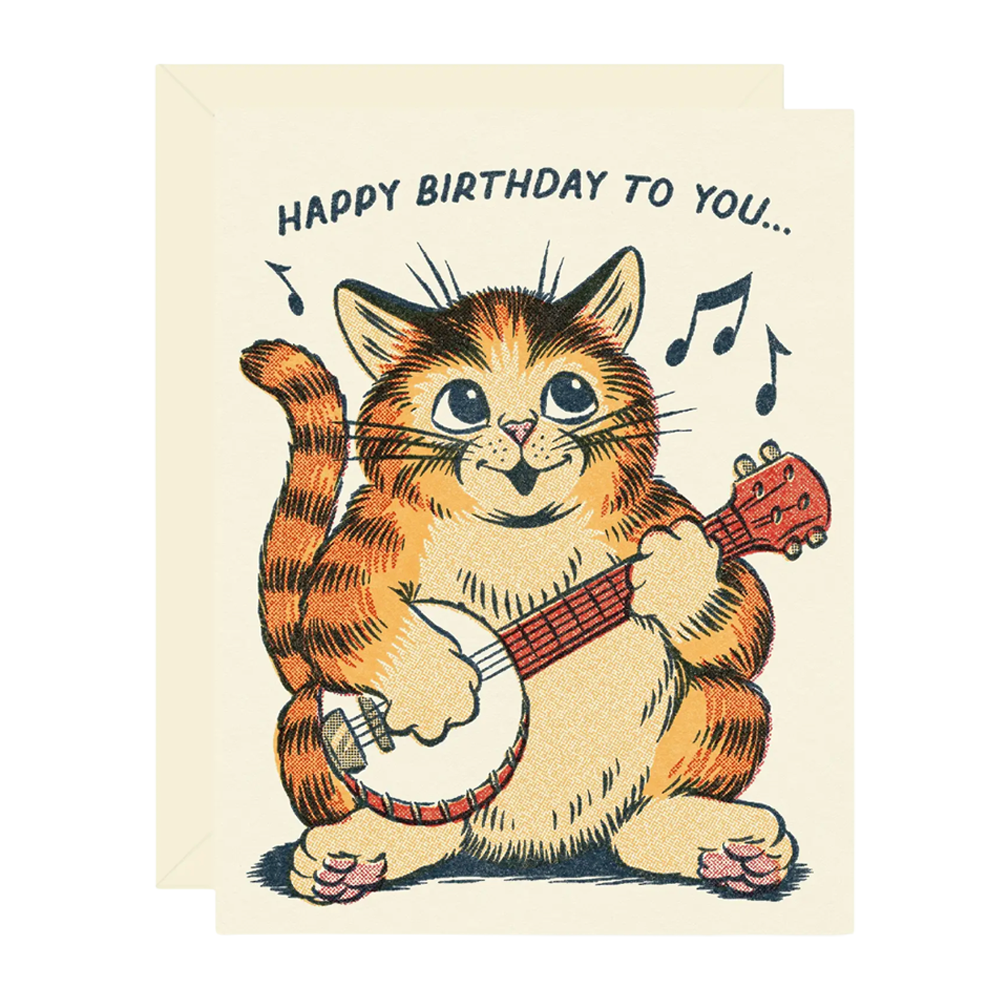 A birthday greeting card featuring a cartoon orange tabby cat playing a banjo, with the text 'HAPPY BIRTHDAY TO YOU.
