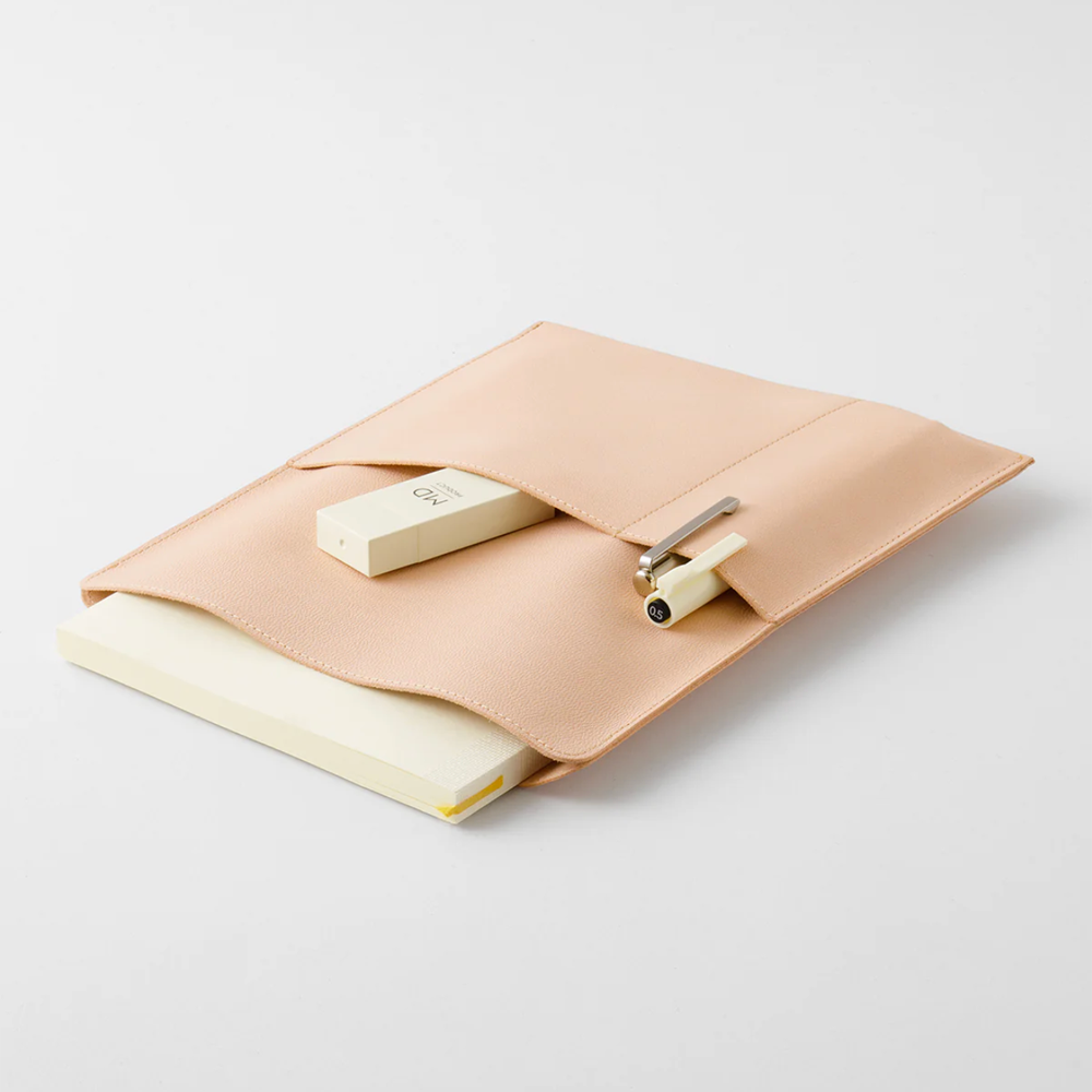 Beige leather notebook bag with a notebook inside, two pens, and a correction tape.