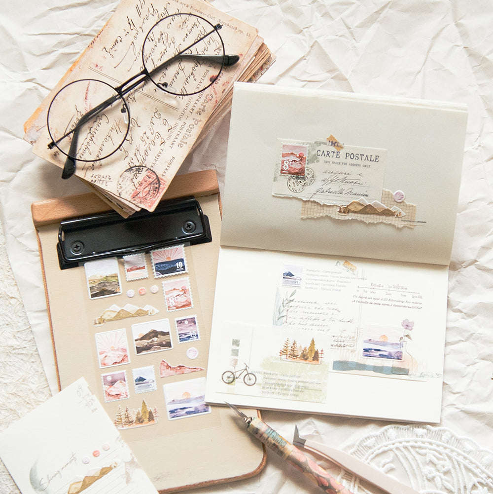 Stationery items including a letter, stamps, a pen, and glasses on a textured surface.