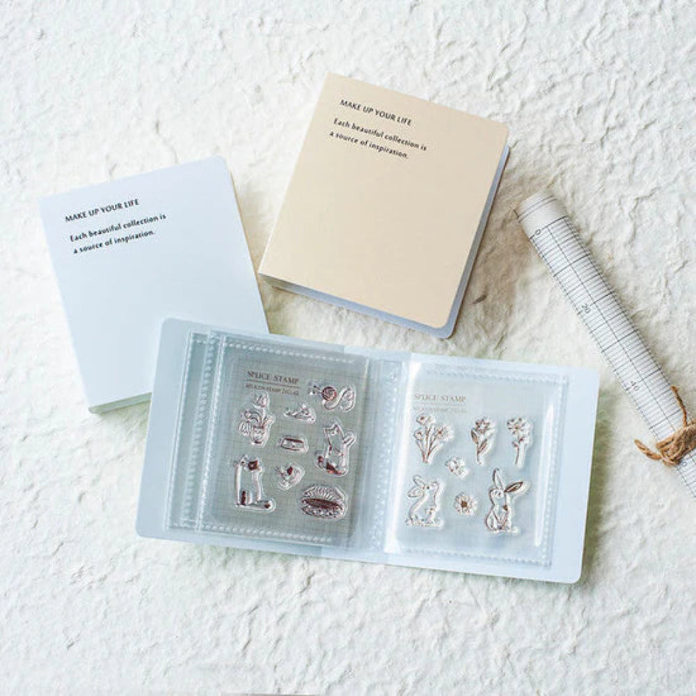 Set of clear stamp sets in a book with notebooks on a textured surface