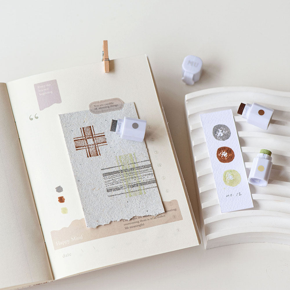 Stationery items including cards and stickers on a white surface with a minimal background.