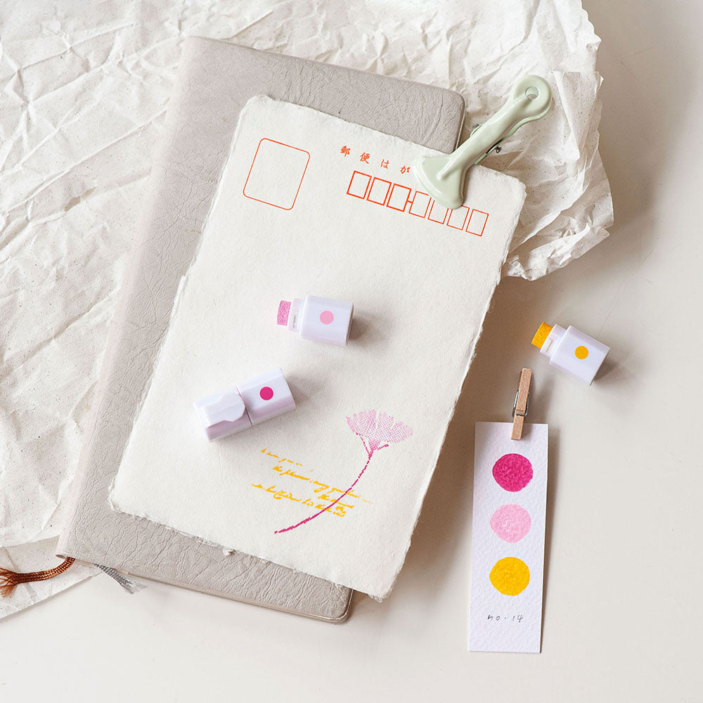 Notebook with stationery items on a textured surface