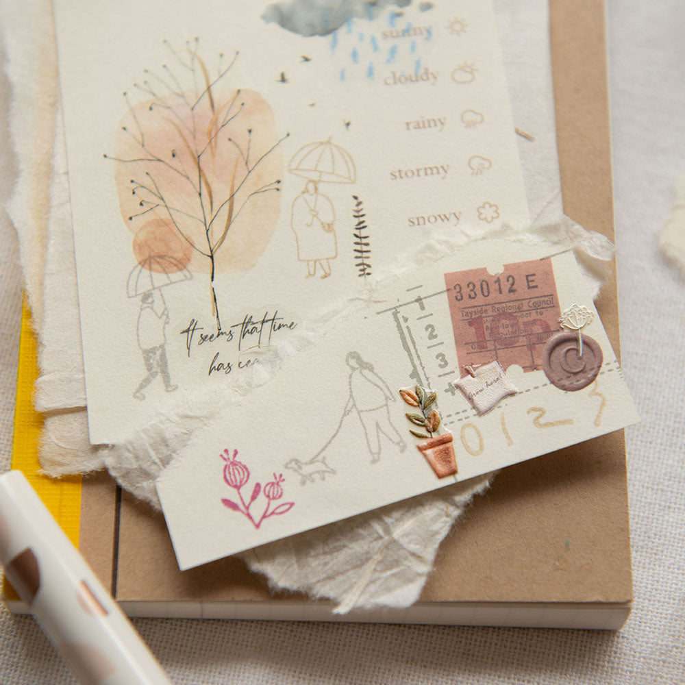 Stack of cards with illustrations and text on a textured surface