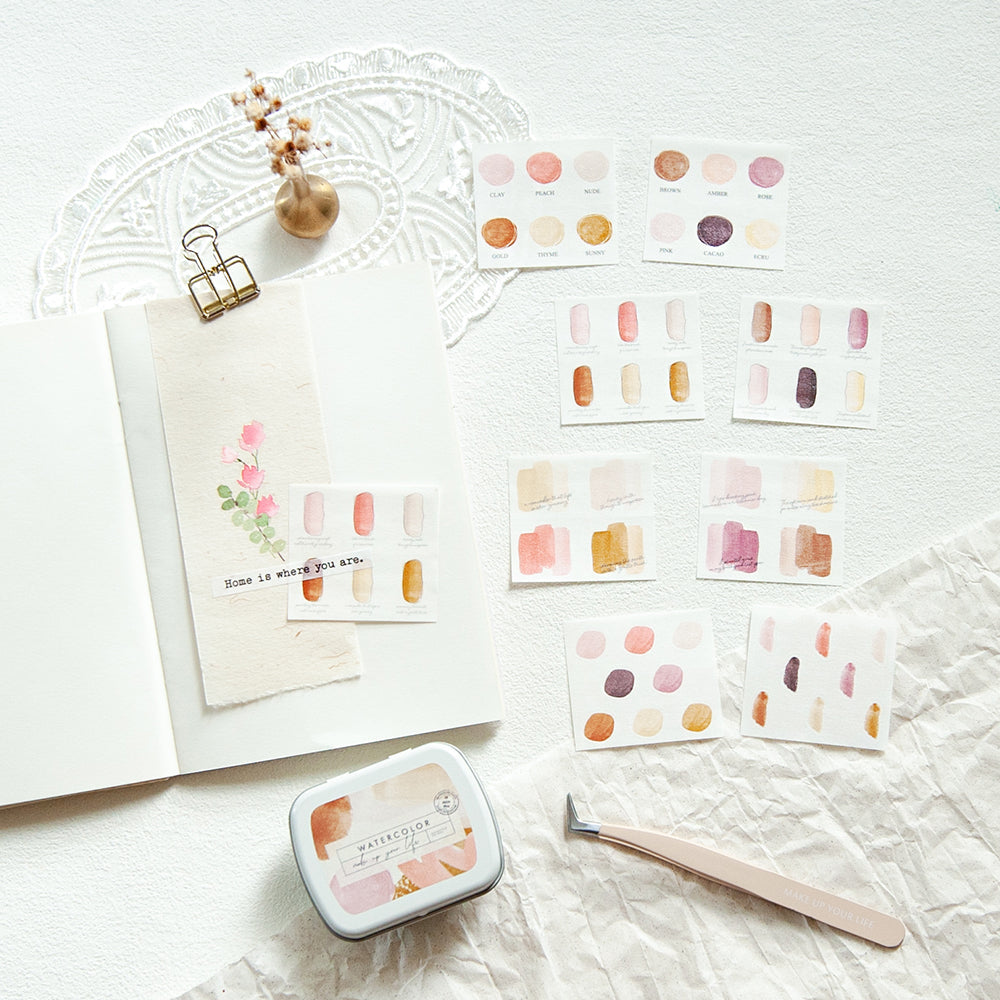Color swatch cards with a small ink pad and brush on a textured surface