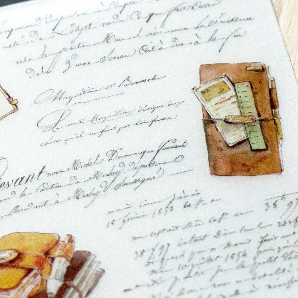 Decorative stationery items on a sheet of paper with cursive writing