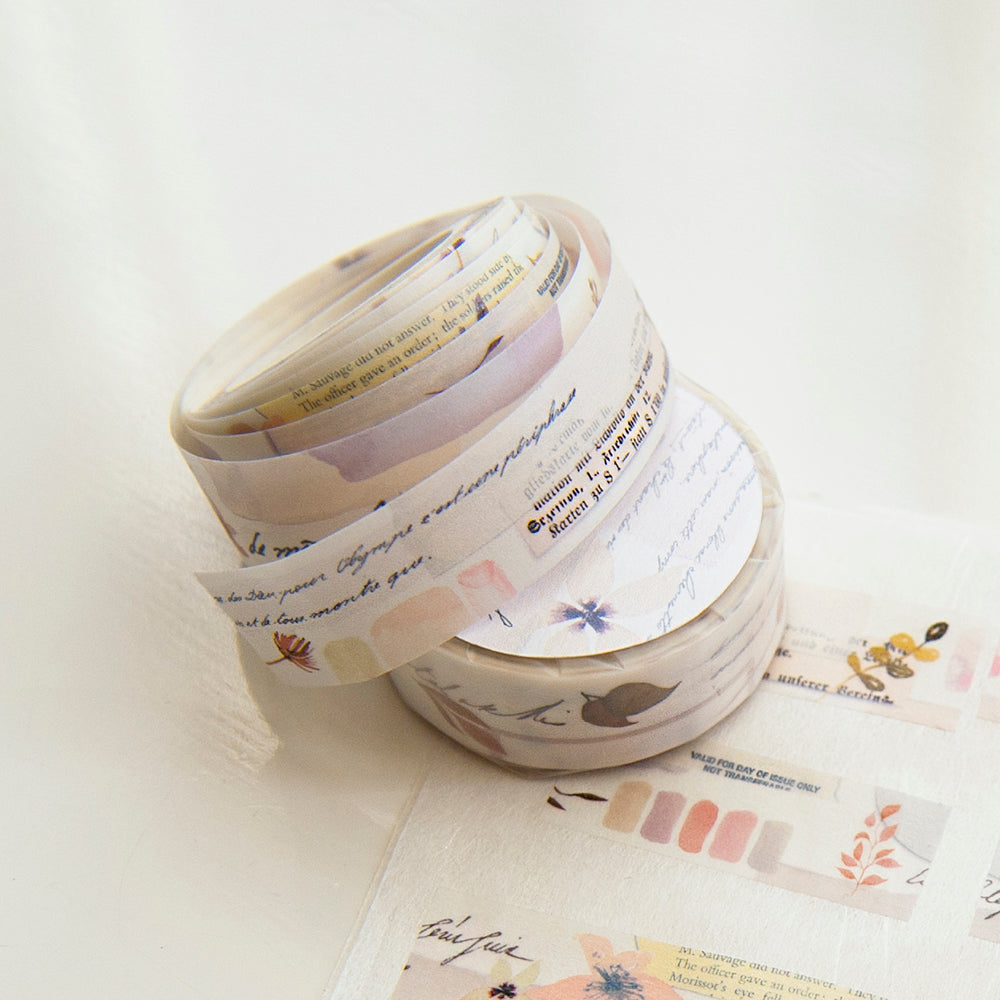 Roll of decorative tape with printed designs on a white background