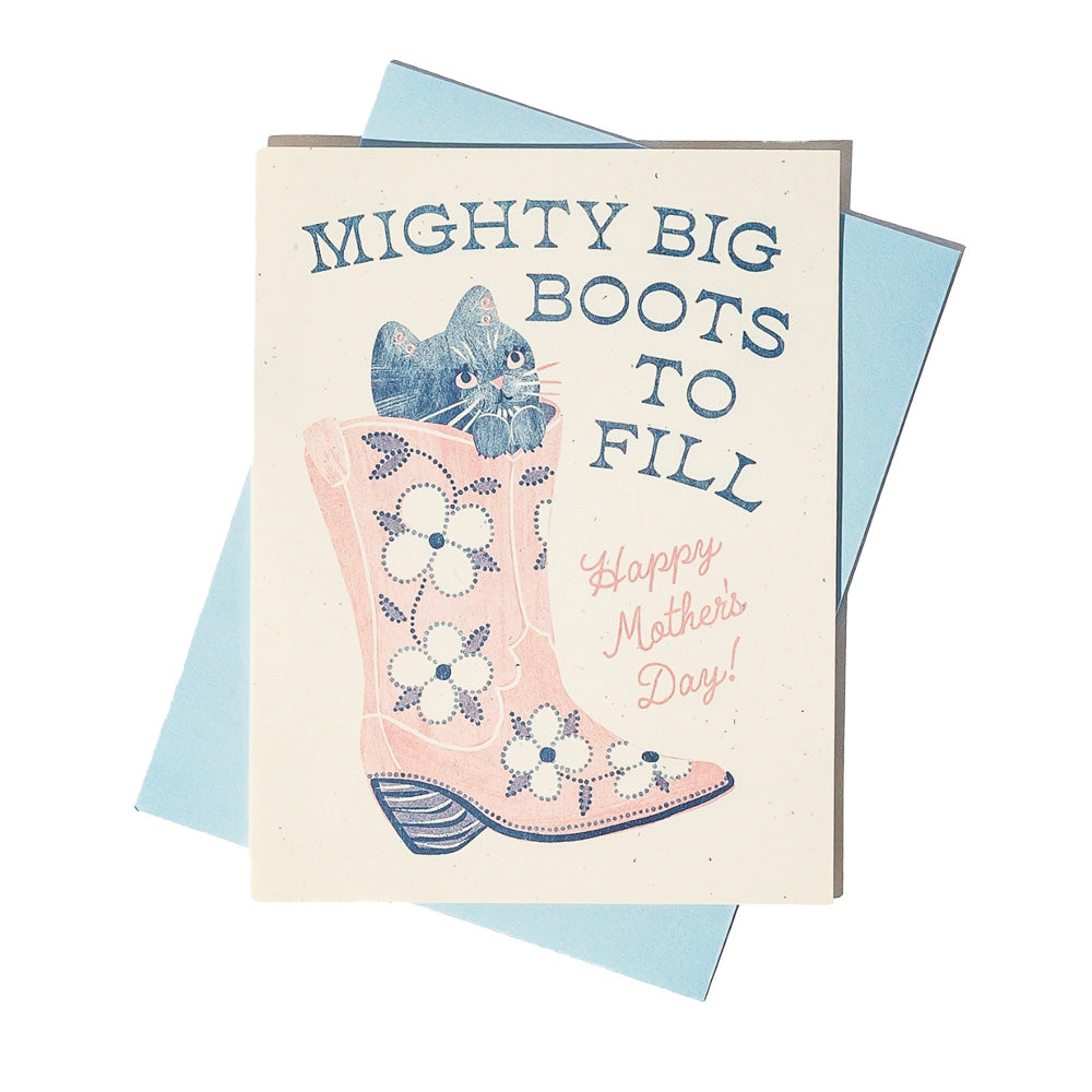 Greeting card with a pink cowboy boot and cat coming out of it, text 'Mighty Big Boots to Fill Happy Mother's Day' on a light blue background.