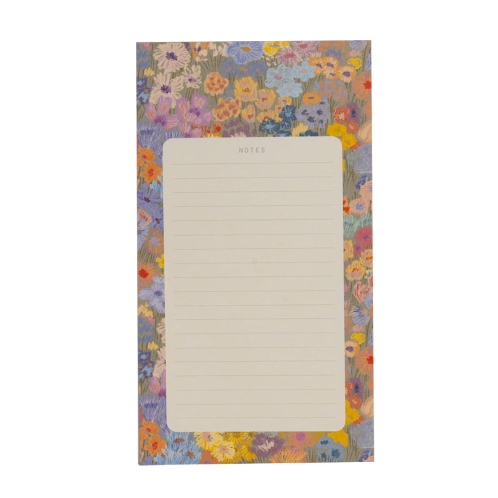 Floral-patterned notepad with a blank page on a white background