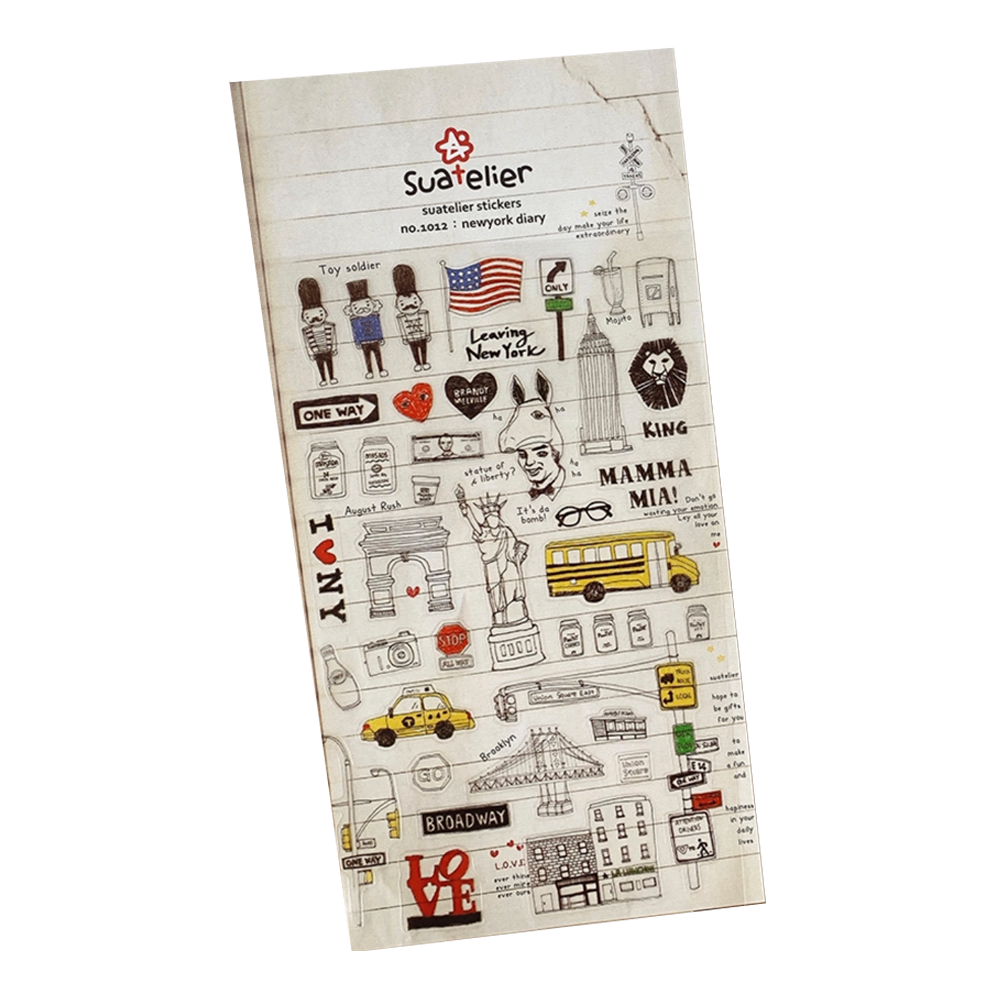 A single sheet of Suatelier 'new york diary' stickers shown at an angle on a plain white background. The stickers feature various New York City-themed illustrations, including a yellow taxi, a school bus, the Statue of Liberty, the Arc de Triomphe, and cartoon characters.