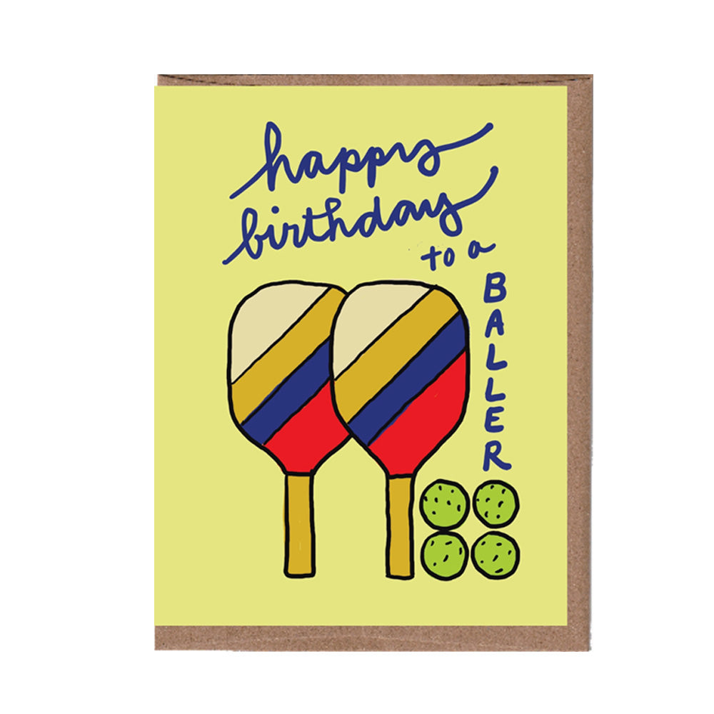 Birthday card with pickleball paddles and balls and text 'Happy birthday to a baller' on a yellow background