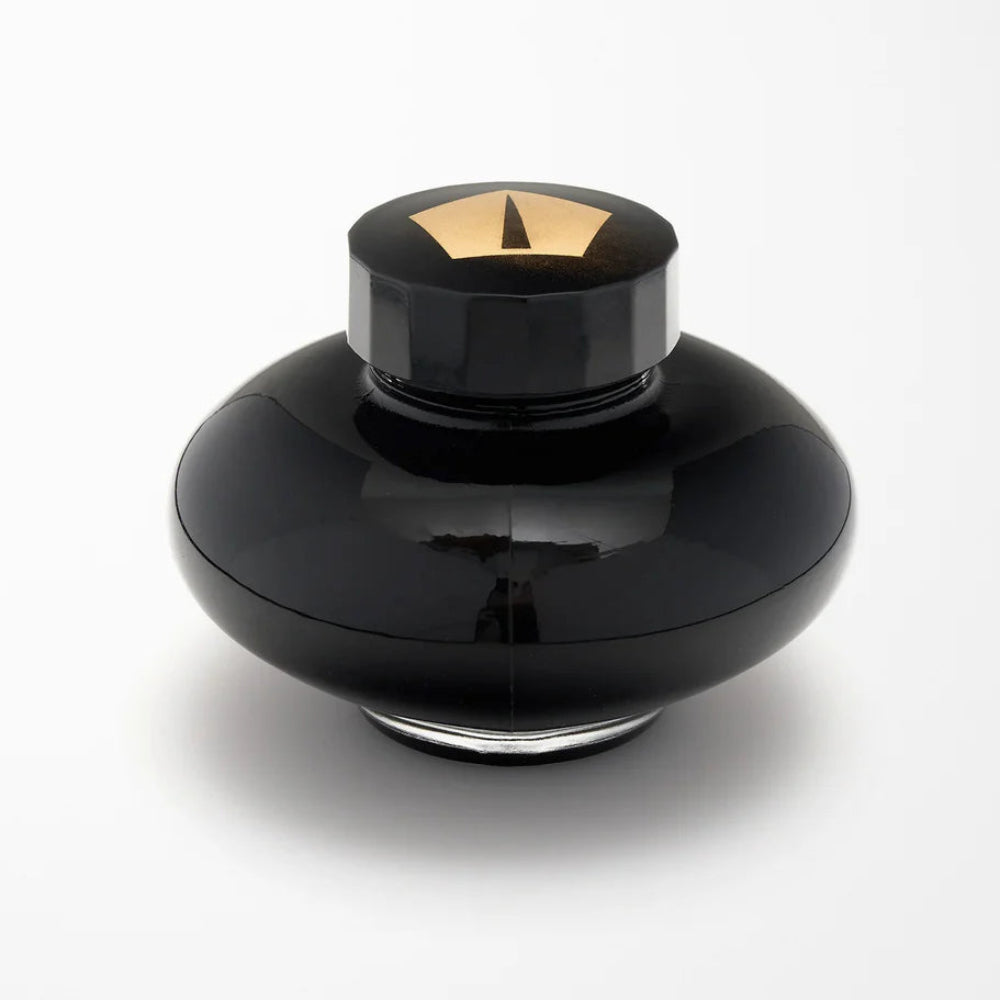 Black bottle with gold top on a white background