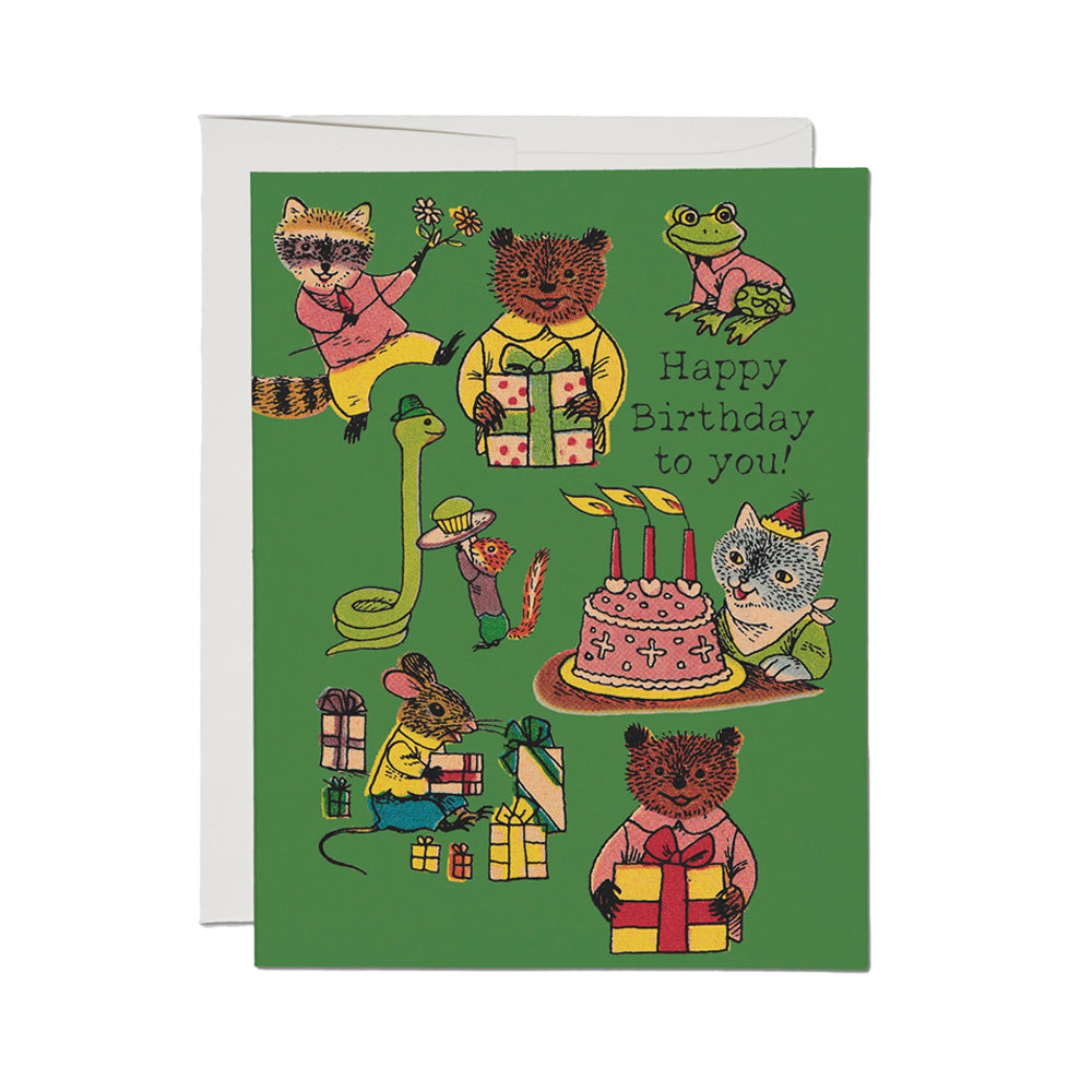 Birthday card with illustrated animals around a cake and presents on a green background with the words "Happy Birthday to you!" on the right.