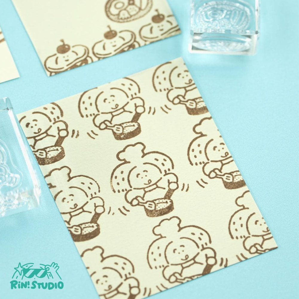 Sheet of paper with cartoon character pattern on a blue background, featuring the Rin Studio logo.