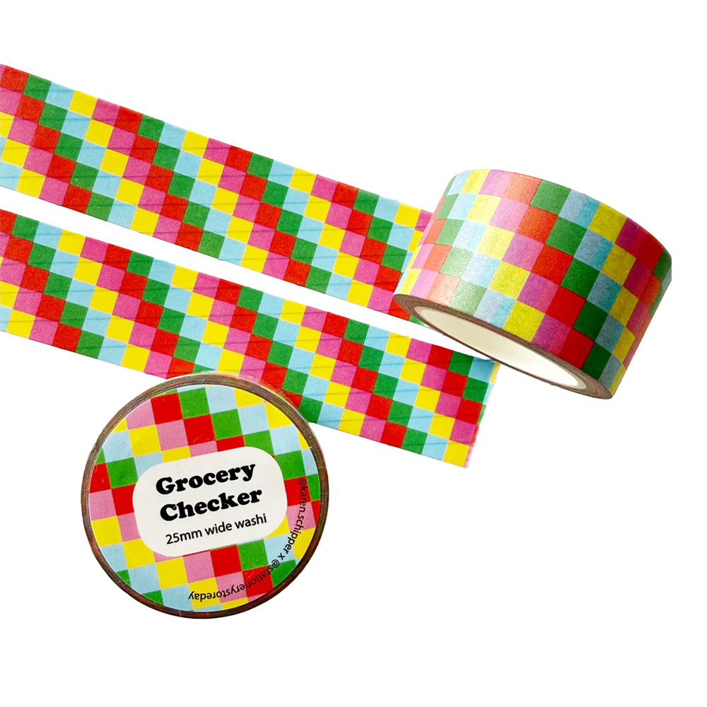 A roll of washi tape with a colorful checkerboard pattern. The label on the roll reads 'Grocery Checker 25mm wide washi'.