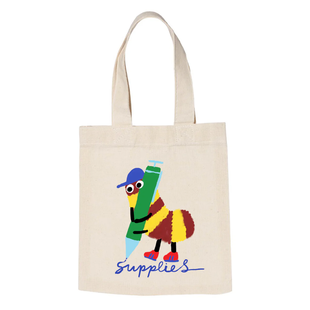 Canvas tote bag with scribble bug writing "supplies" in cursive.