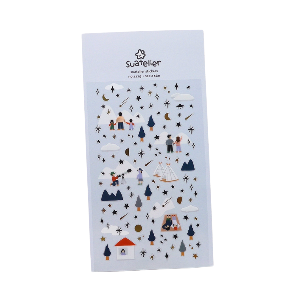 A single sheet of Suatelier stickers shown at an angle on a plain white background. The stickers feature various Star and snow details.
