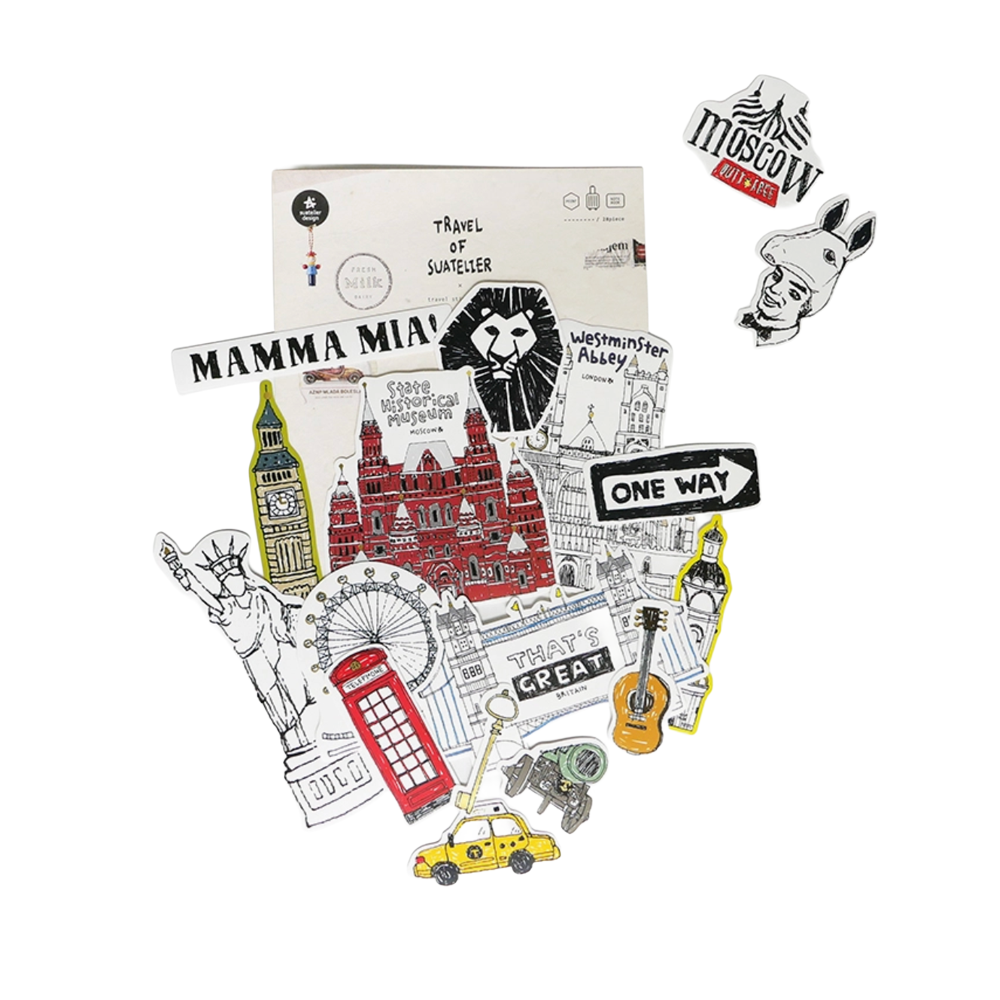 A sticker pack of Suatelier travel stickers shown at an angle on a plain white background. 