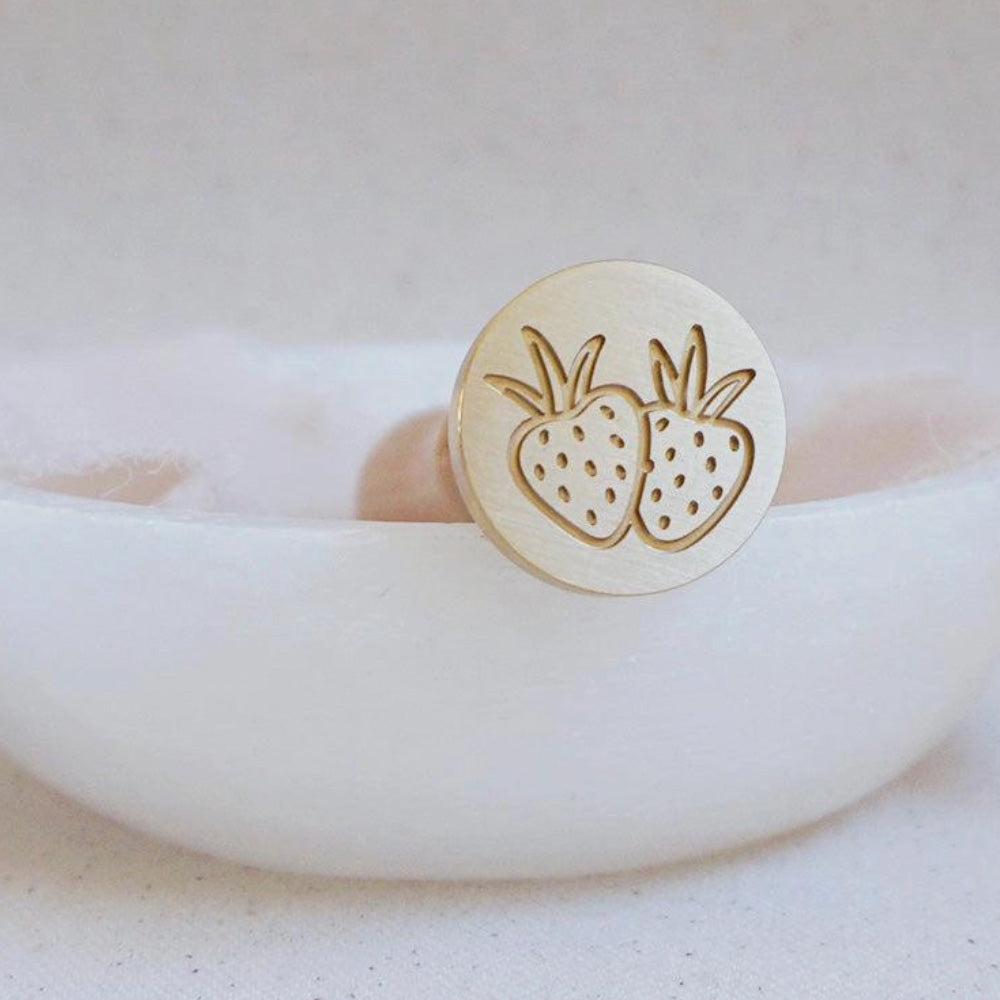 Gold wax stamp head with two strawberries with leaves as the design