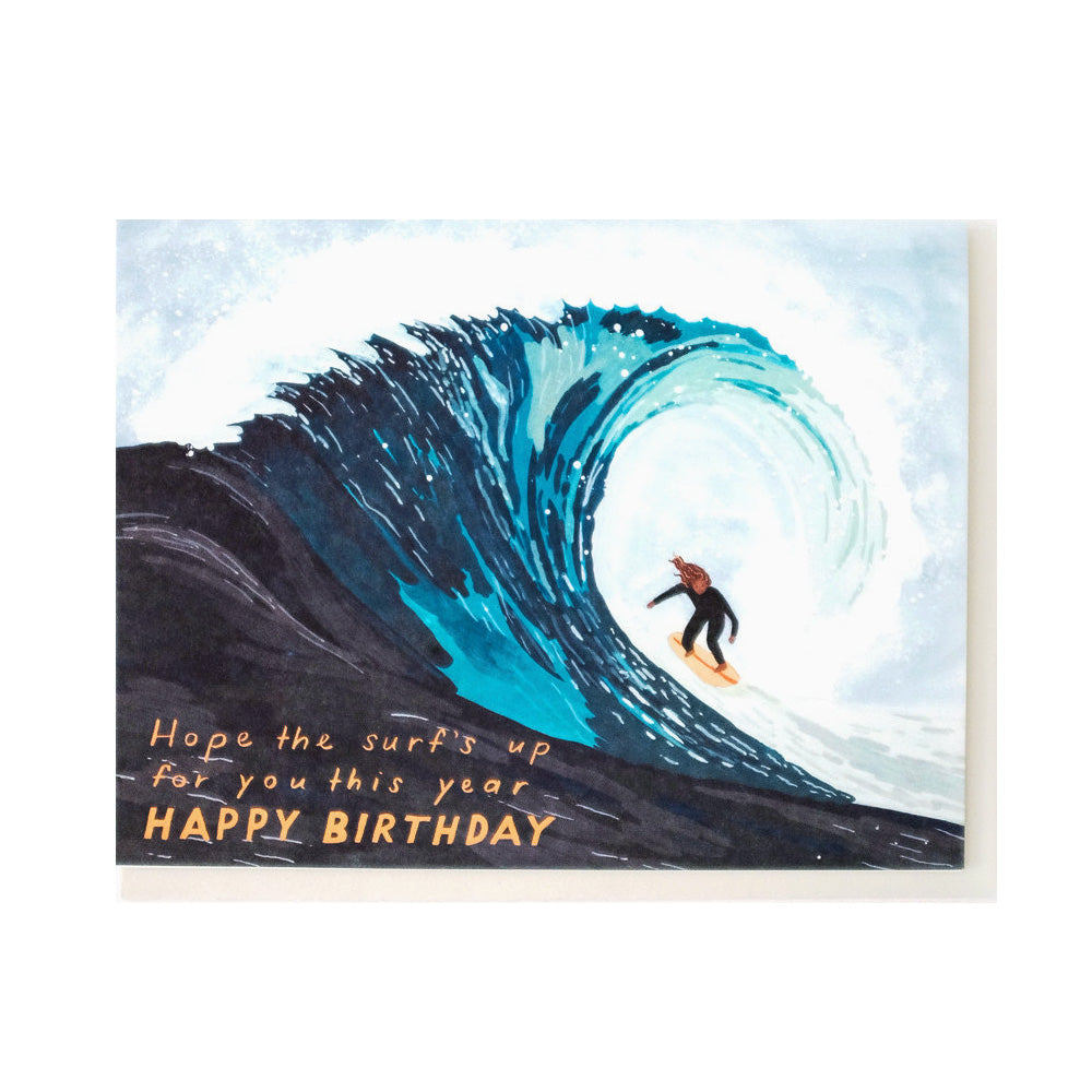 Birthday card with a surfer riding a wave and text 'Hope the surf's up for you this year HAPPY BIRTHDAY'.