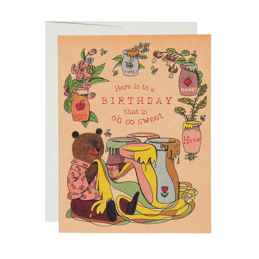 Orange card with an illustration of a bear drinking various pots of honey with flowers and bees. Text reads, "Here is to a birthday that is oh so sweet"
