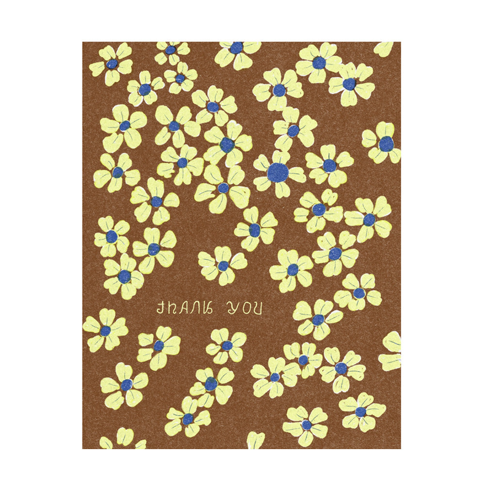 Card with yellow flowers and blue centers on a brown background with text 'Thank You'